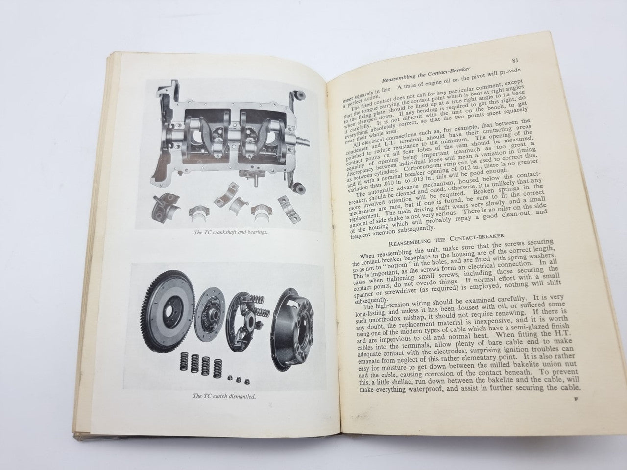 Open vintage car maintenance manual with engine parts diagram and hardware illustrations