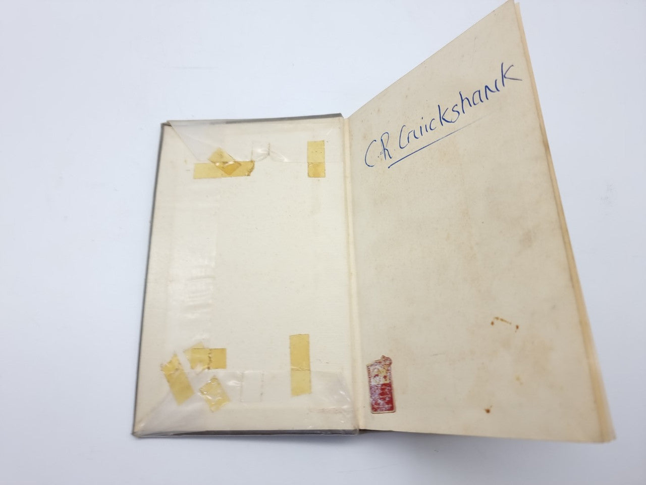 Vintage car maintenance manual with handwritten note "Crankshaft" on the cover