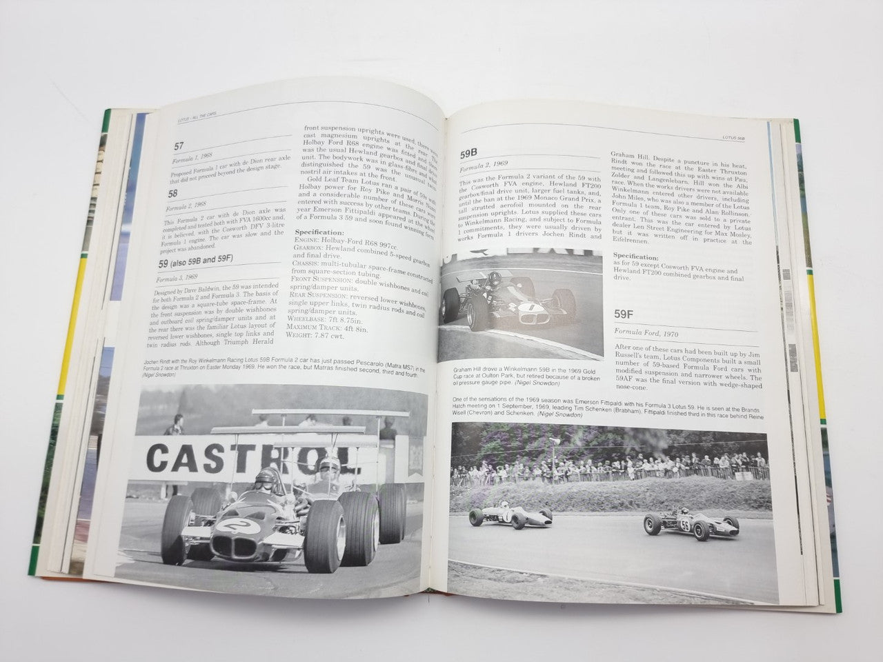 Opened motorsport photo book with black-and-white race car pages and captions