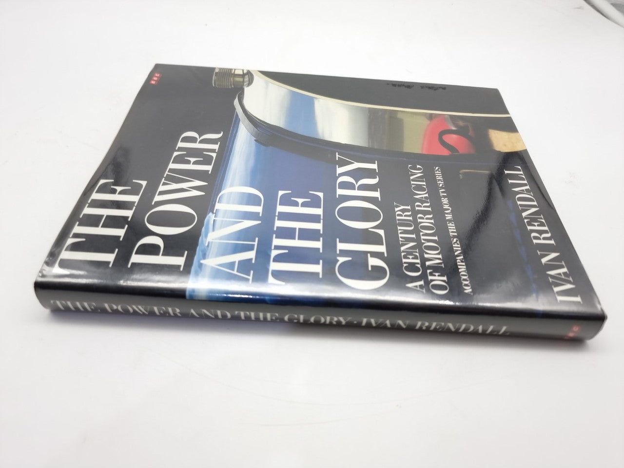 Motor racing book cover with bold title text and vintage car photo graphics