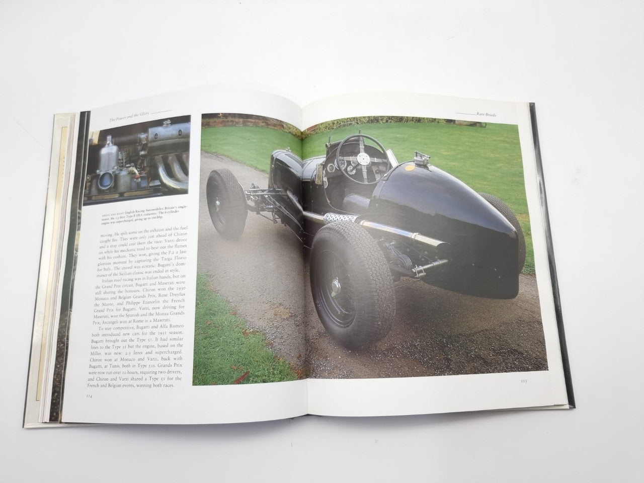 Open motor racing history book with race car photo spread and text columns