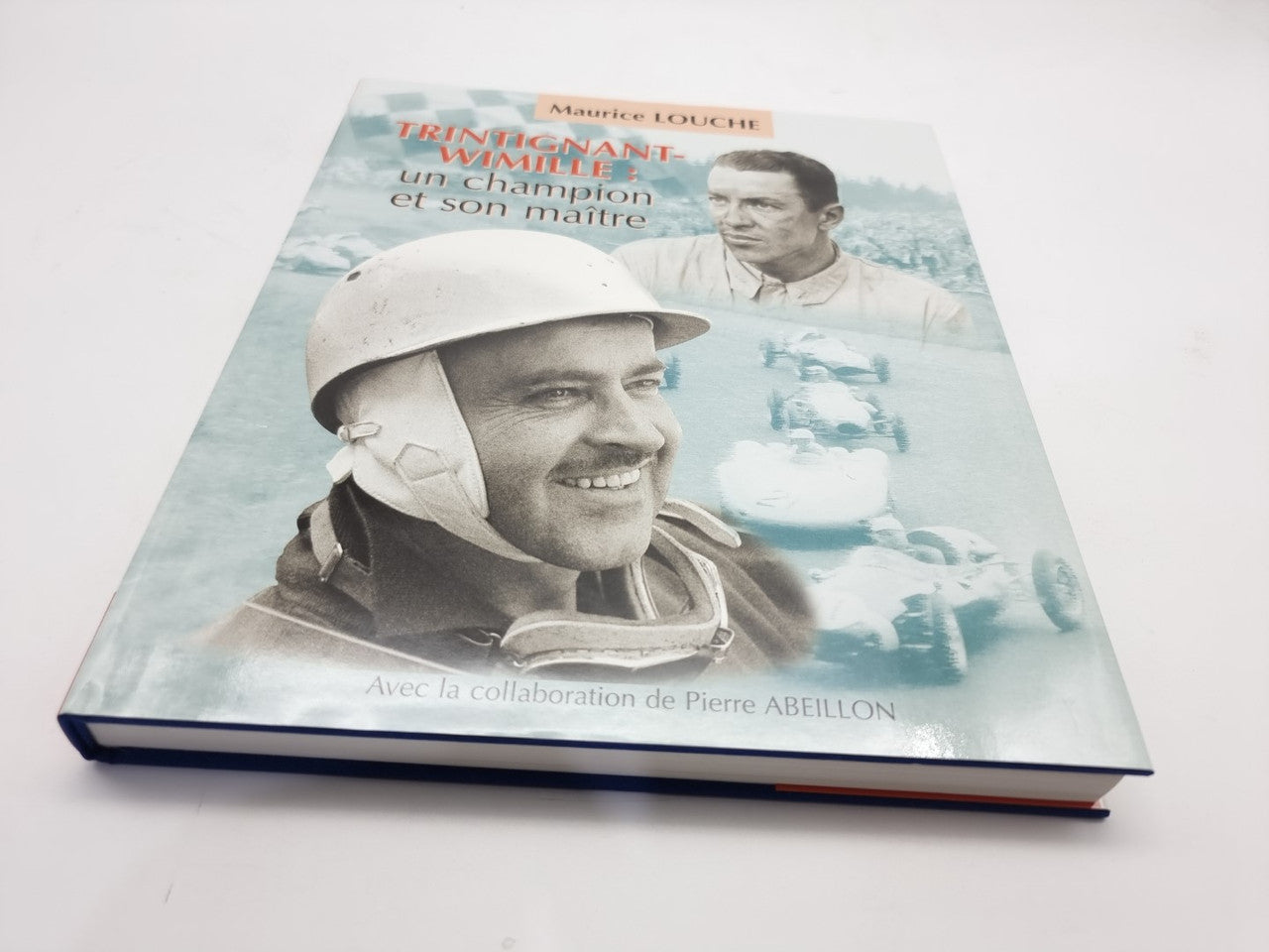 Racing biography book with illustrated cover showing two drivers and sky-blue graphics