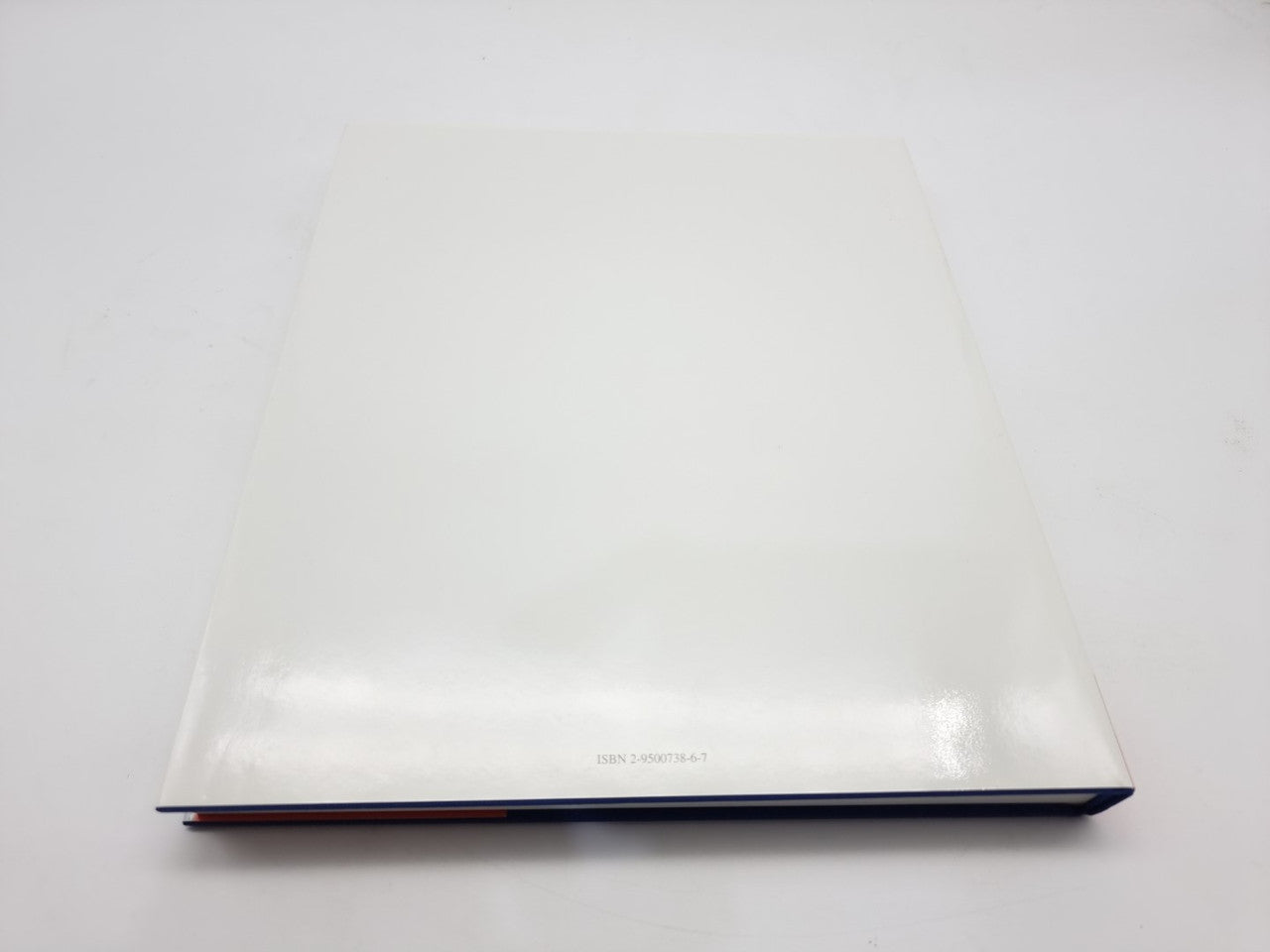 Racing biography book back cover with white design and thin dark blue edge