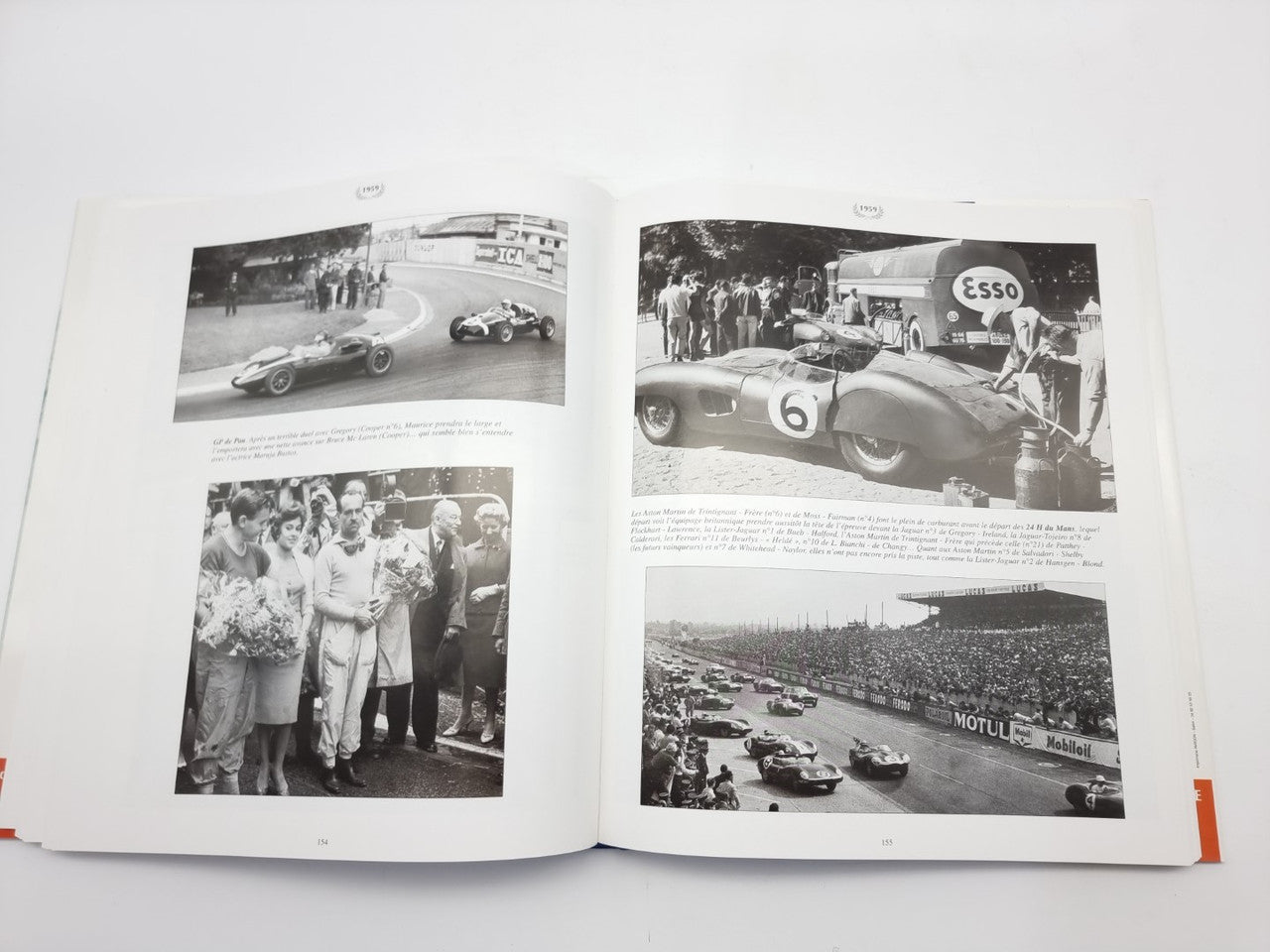 Racing photo book, open spread with black-and-white race cars, crowds, and track scenes