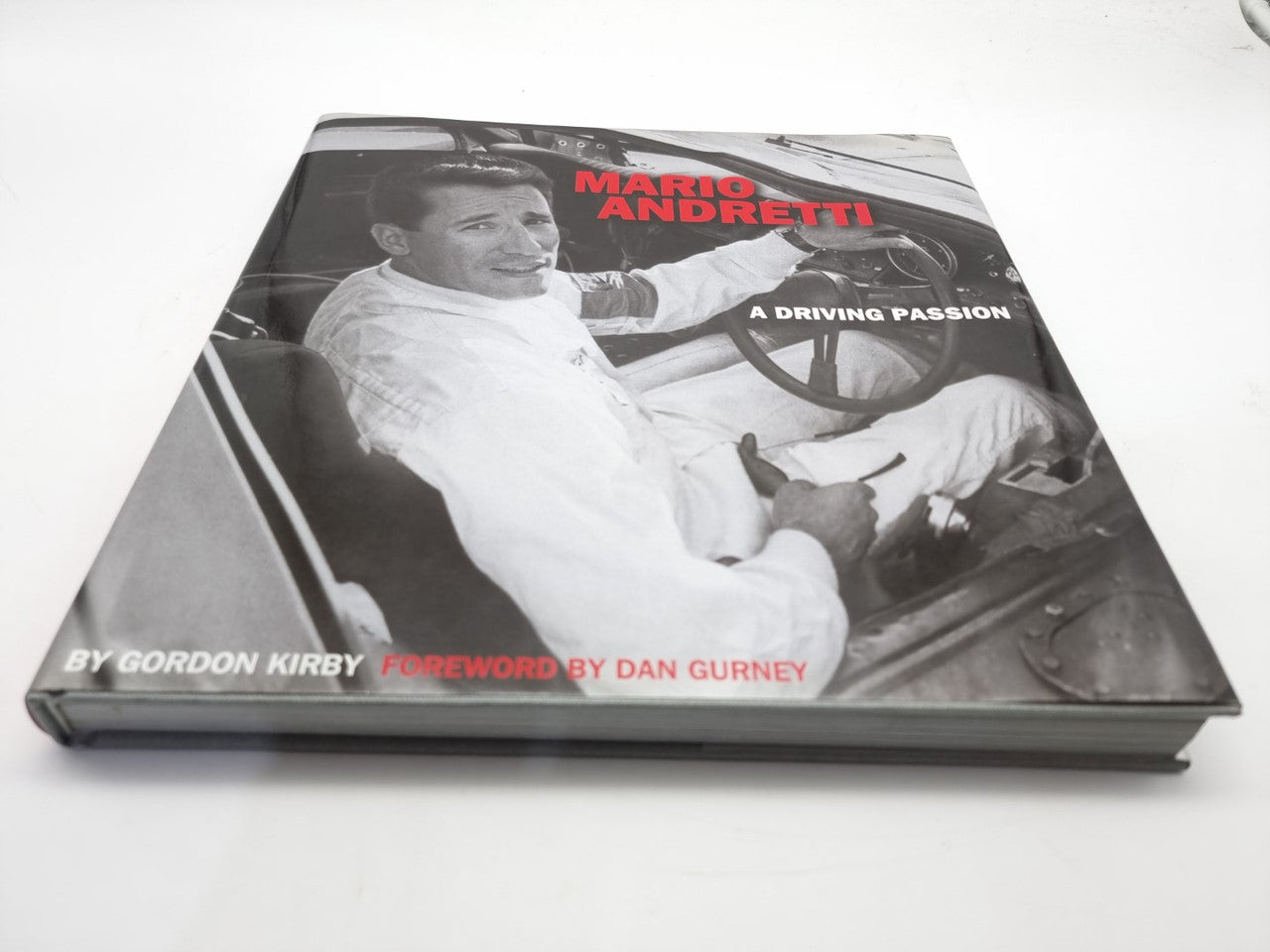 Race car driver book with gray front cover, Mario Andretti title and author text