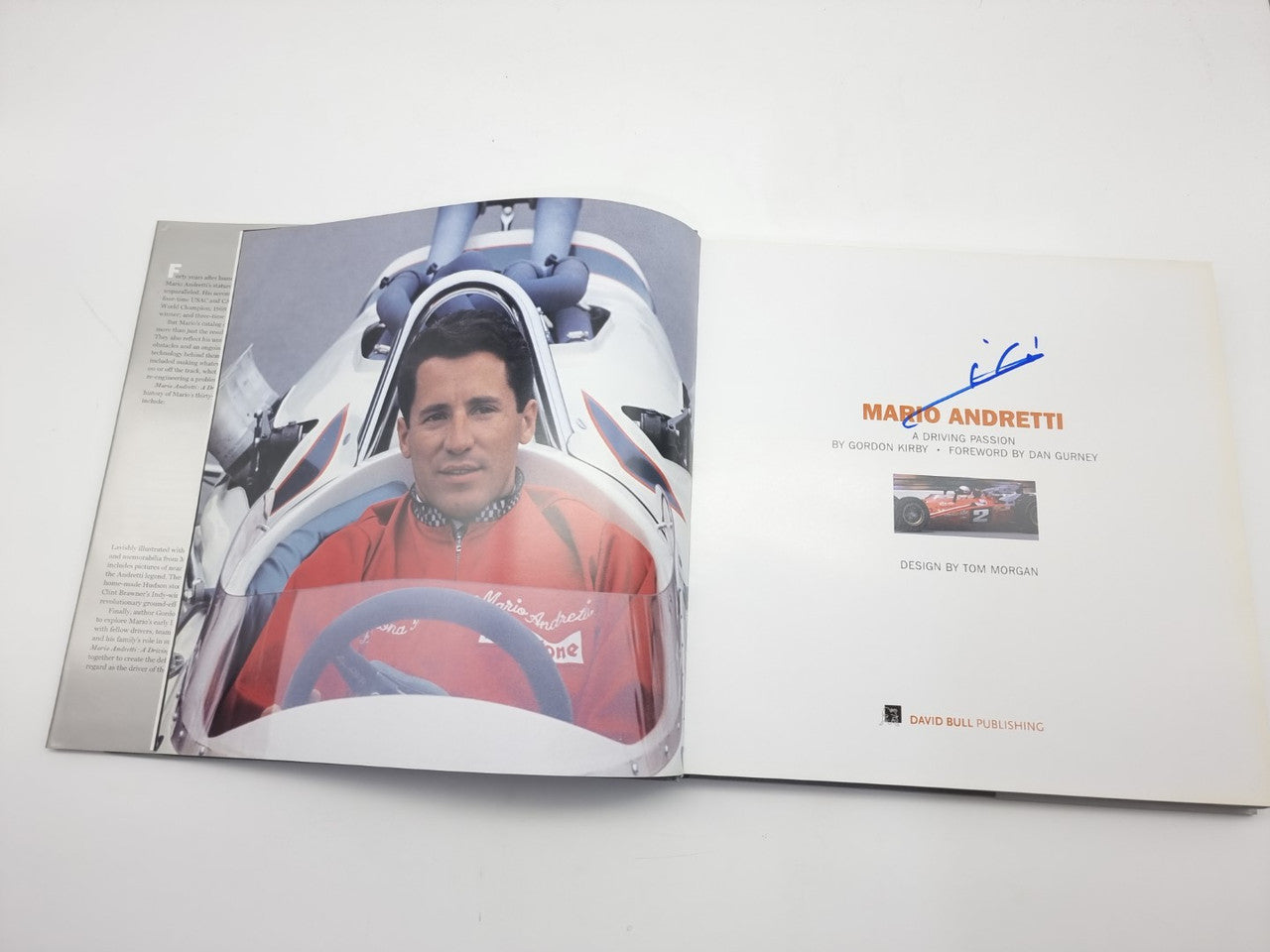 Racing book open spread with driver portrait, title text on right page