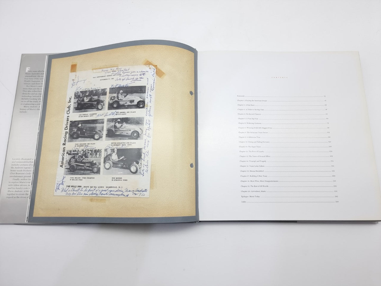 Racing book open to a page with vintage car photo collage on an off-white background