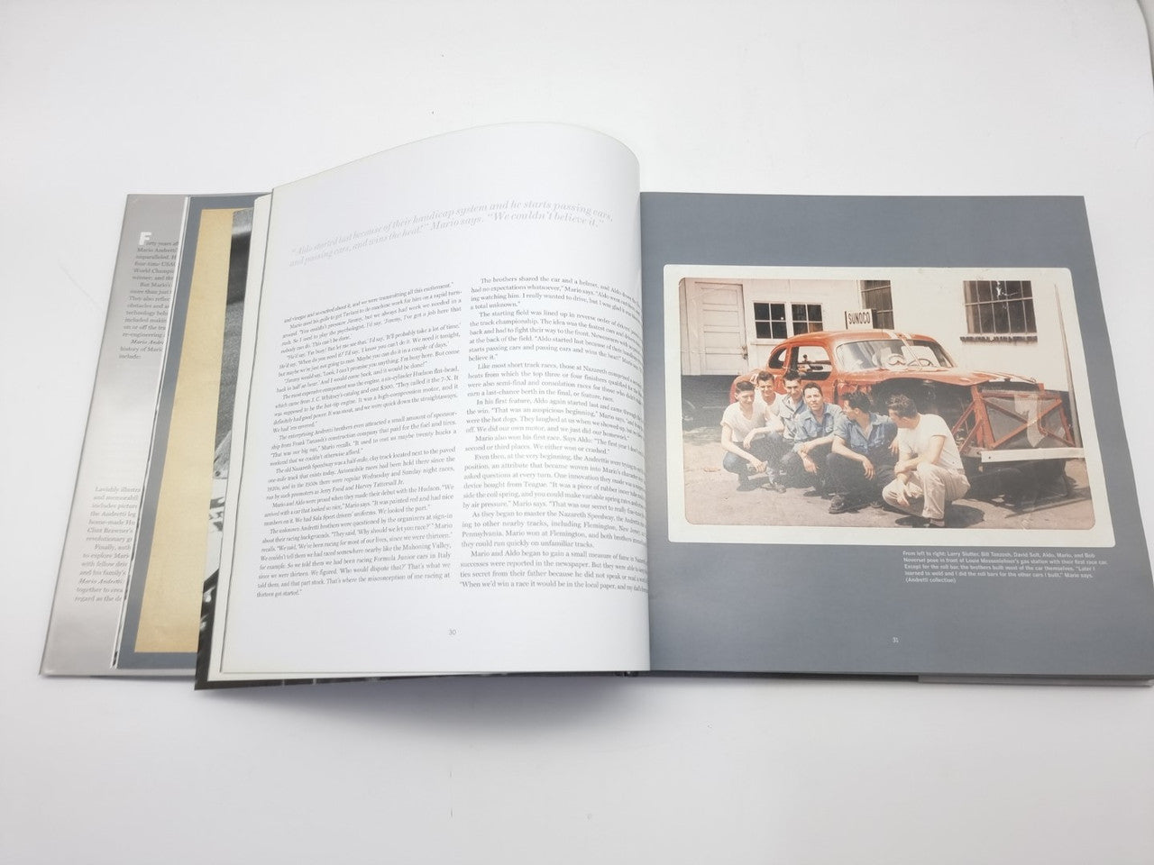 Racing book open with text paragraphs on left and a group photo on the right