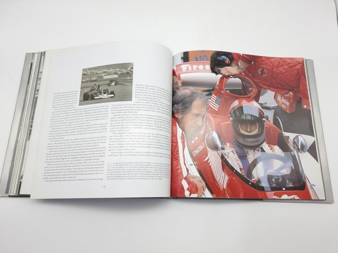 Open motorsport book with text on the left and close-up photo of a red race car.