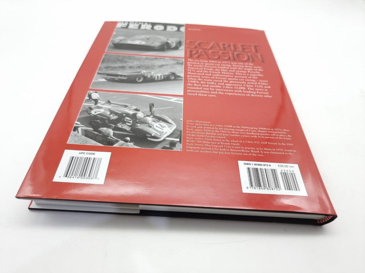 Back cover of red hardcover book with photos, barcode labels, and text panel
