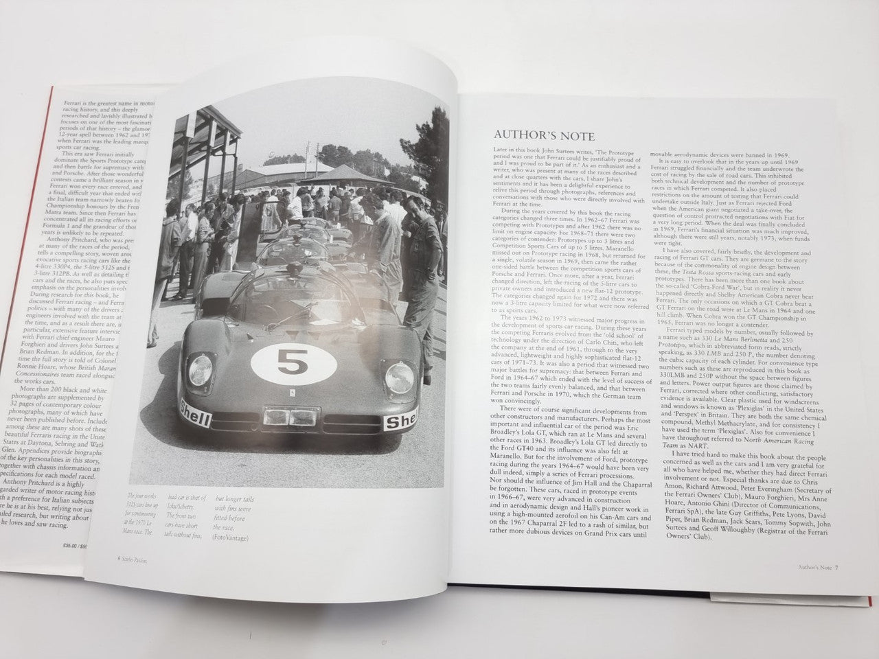 Open automotive history book showing vintage race car photos and author notes text