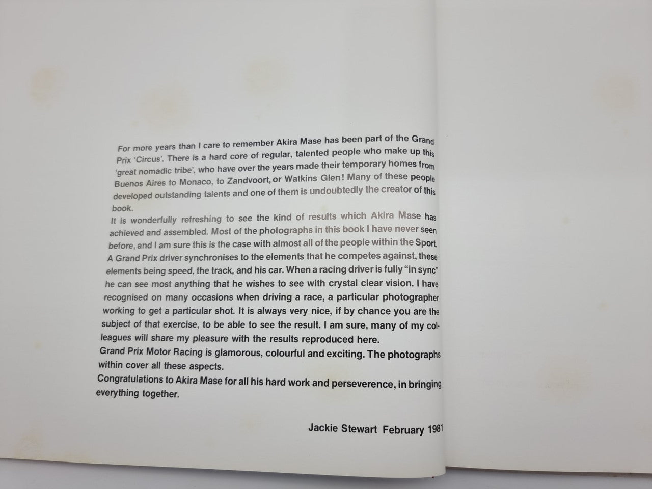 Hardcover book open to biographical text page with signature line