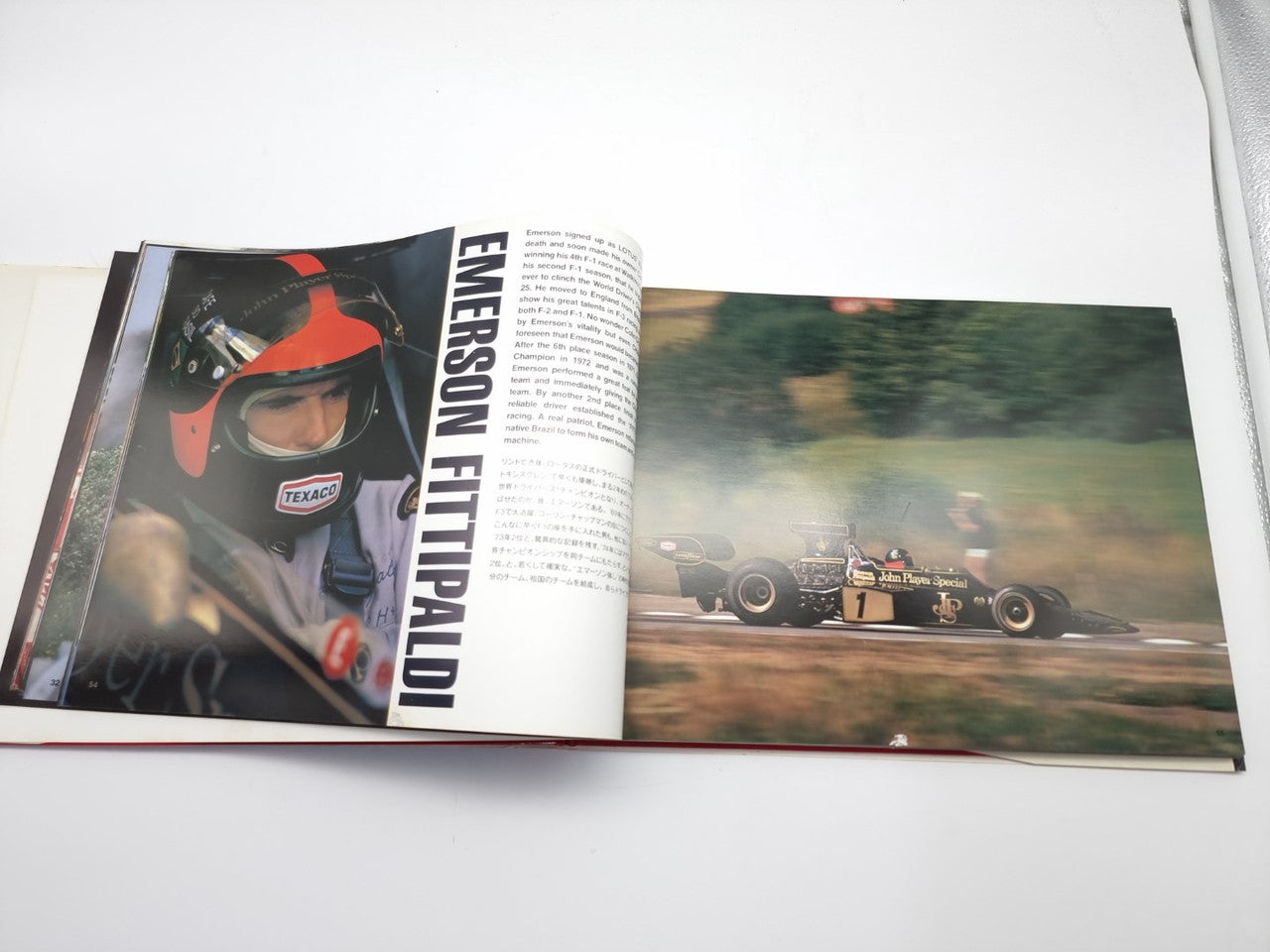 Open motorsport photo book showing racing cars and a driver portrait