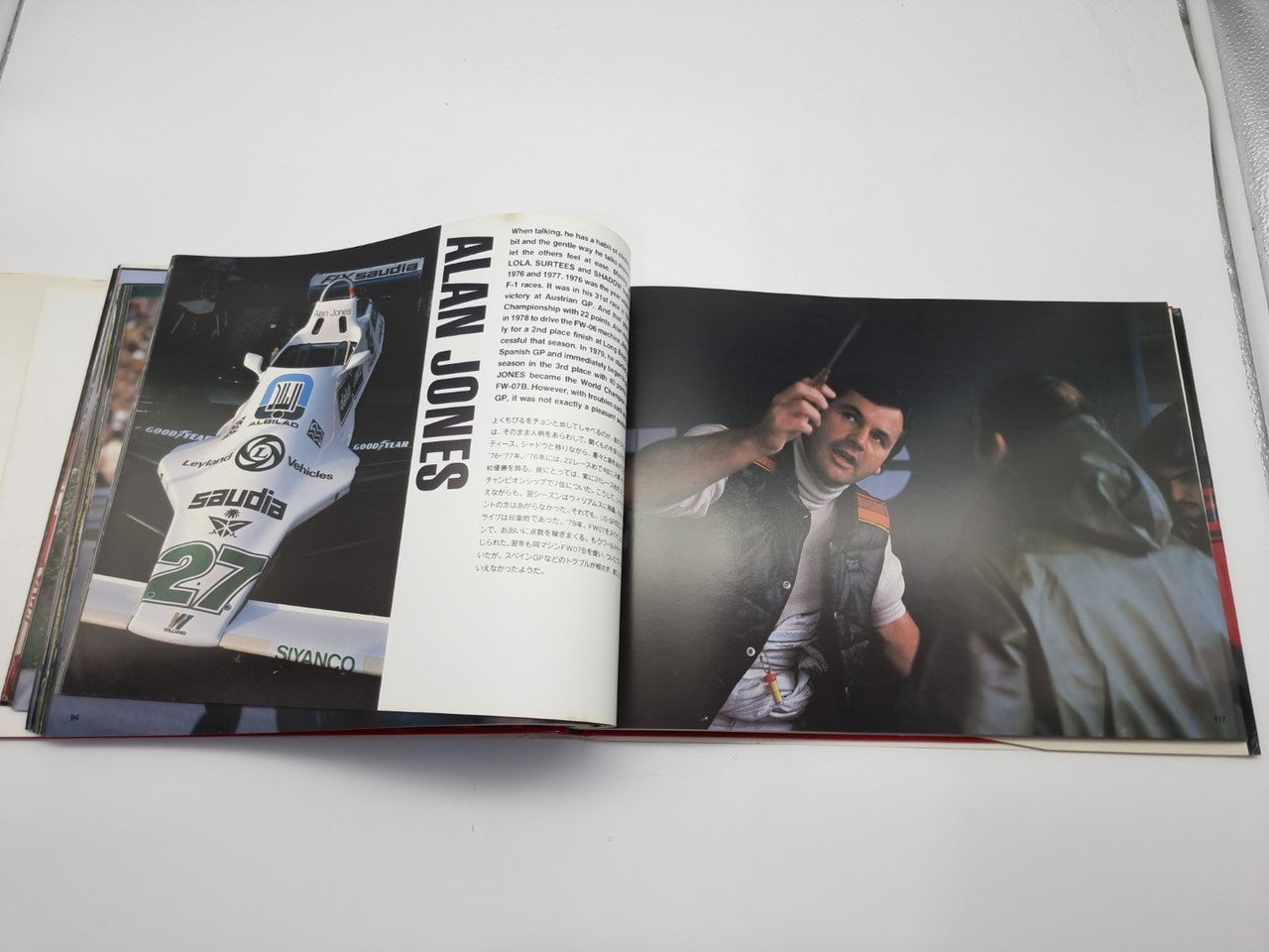 Open motorsport photo book featuring sponsor-style car image and smiling driver