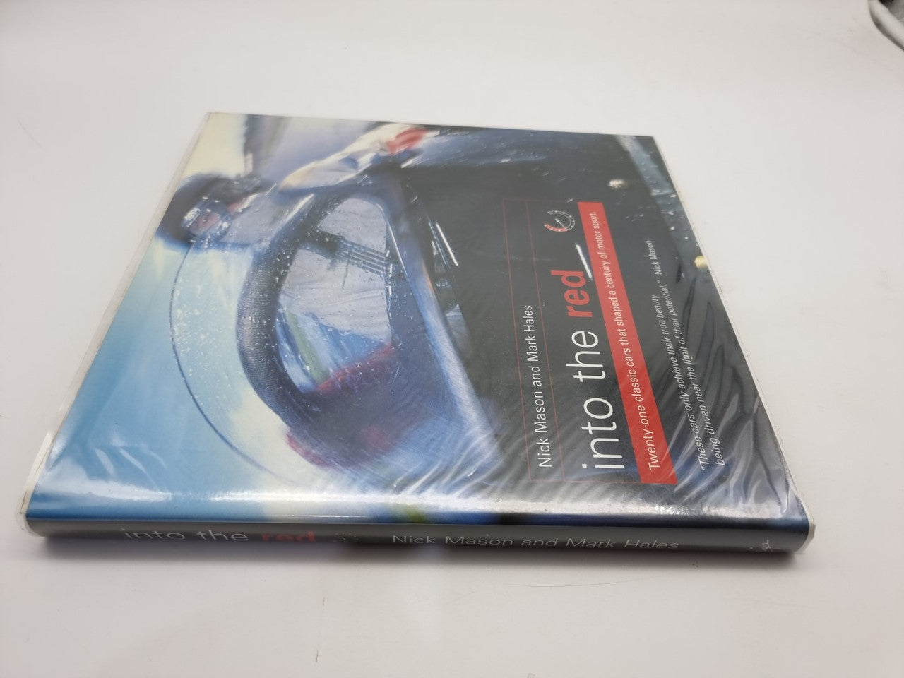 Signed motorsport history book with blue car cover and title on side spine