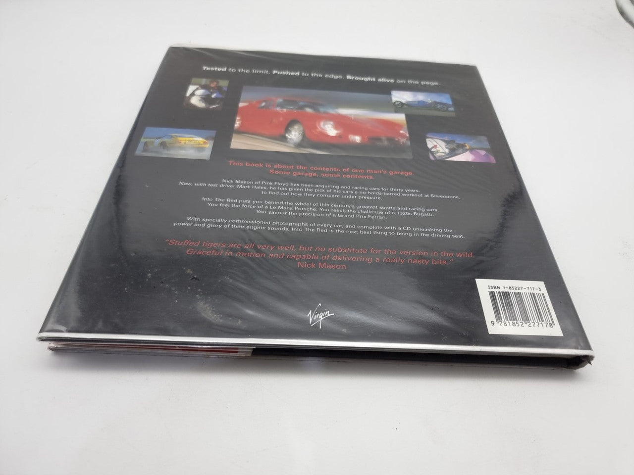 Signed motorsport history book back cover with photo collage and barcode