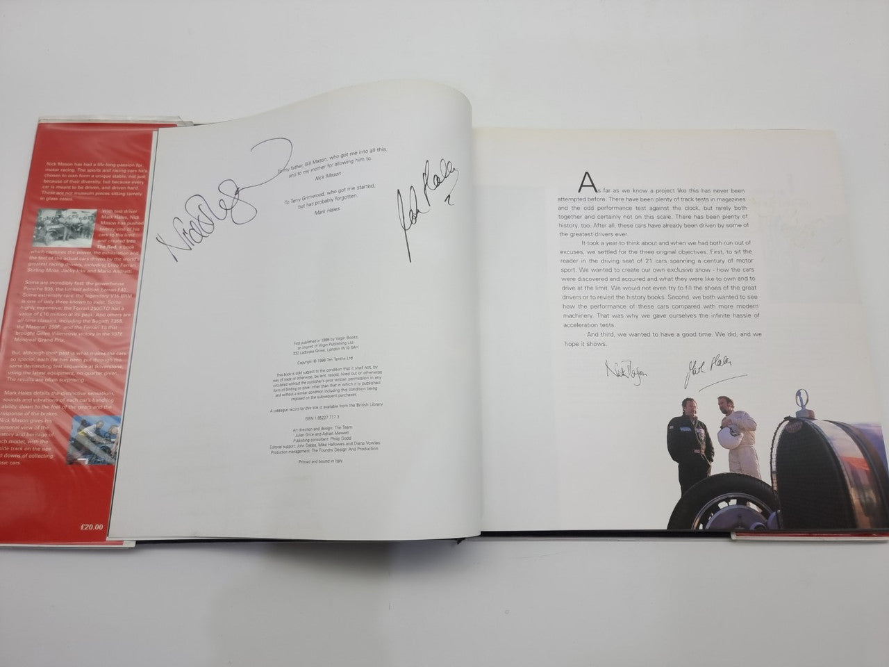 Open signed motorsport history book with handwritten autographs on white pages