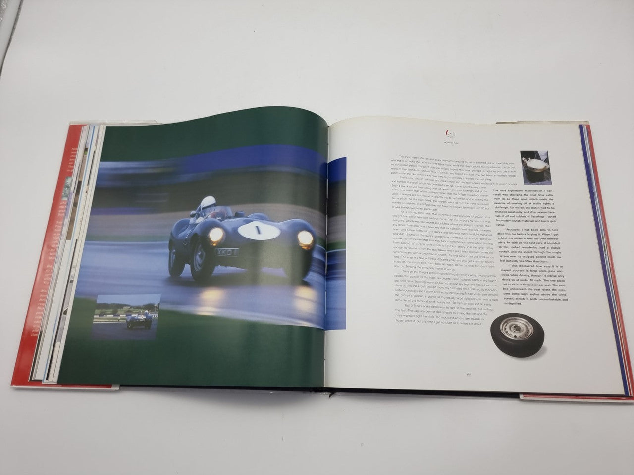 Open hardcover book showing a blue race car photo spread with paragraphs on the right page