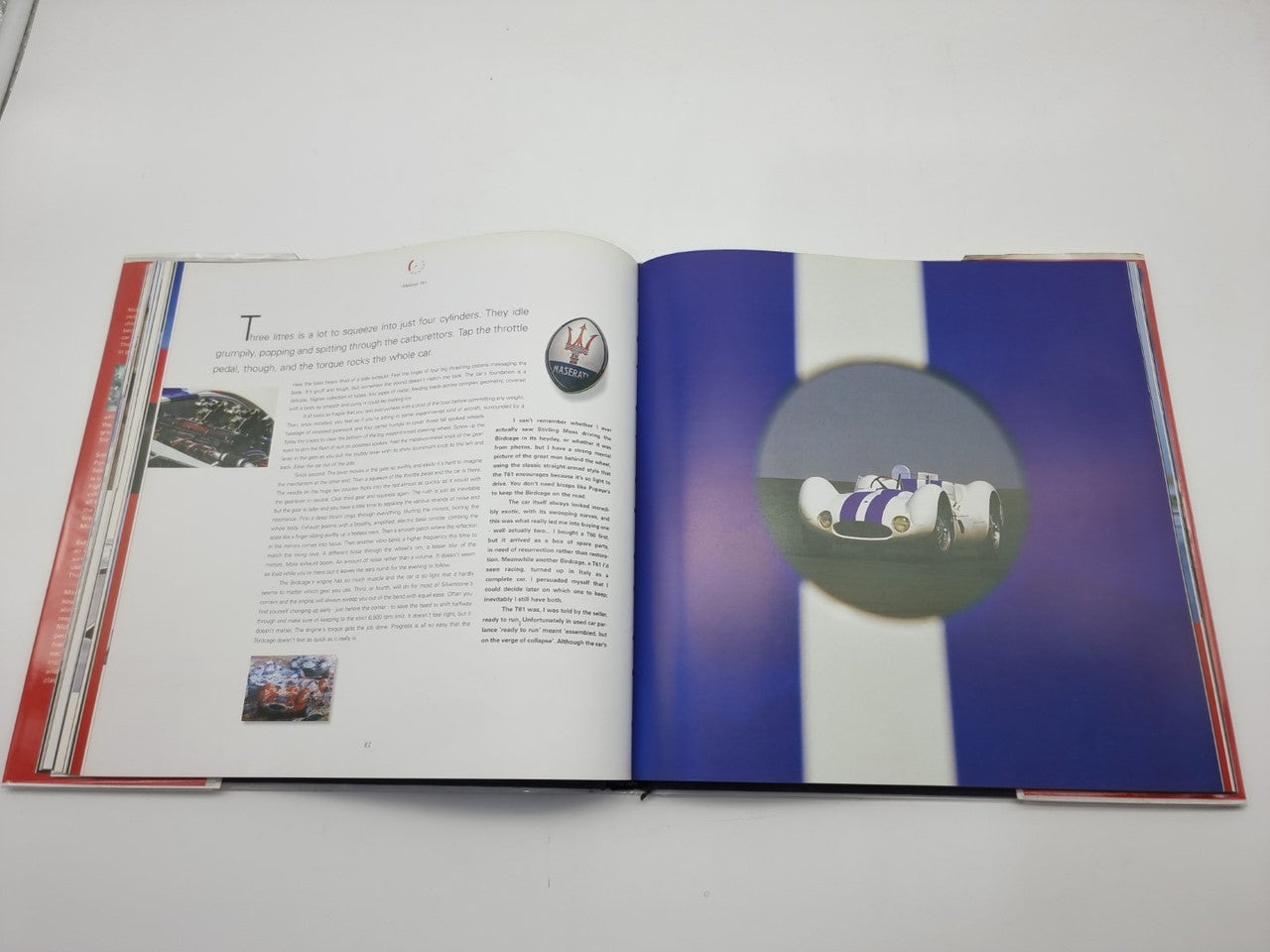 Open hardcover book with a racing car photo on the right page and text on the left