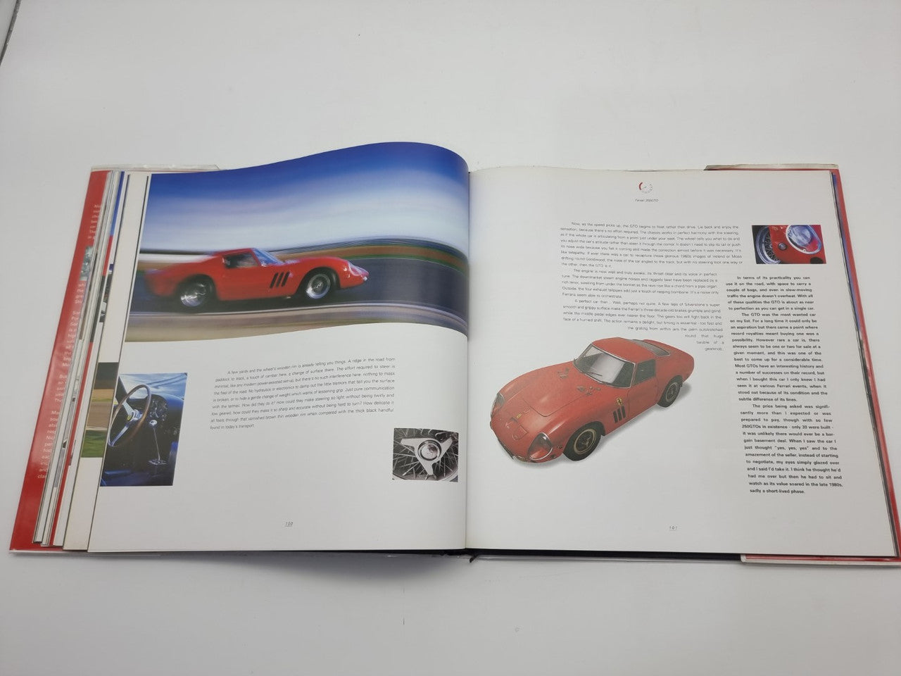 Open hardcover book featuring red race car images and detailed captions across the pages