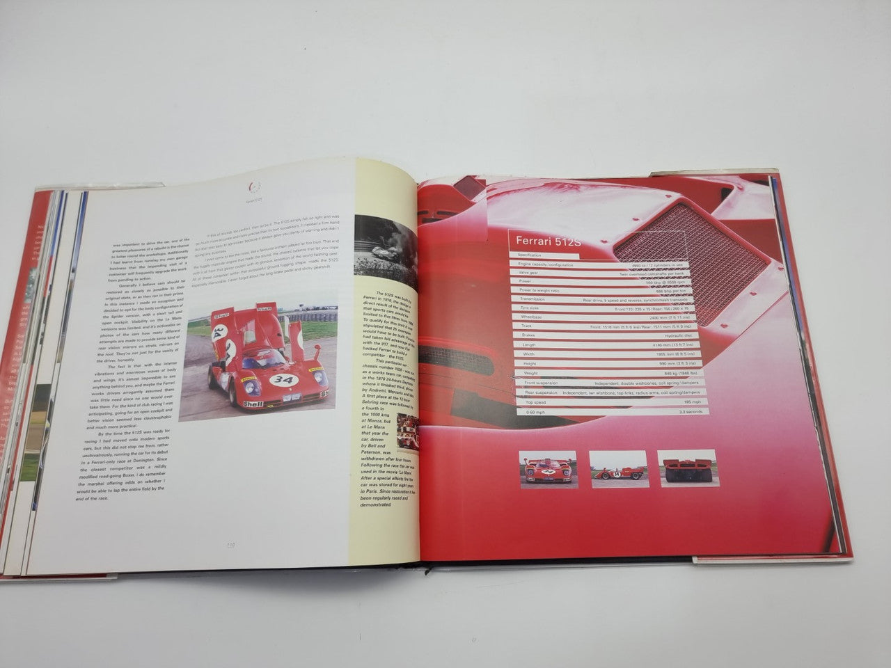 Open hardcover book with a red race car photo and a technical table layout on the right