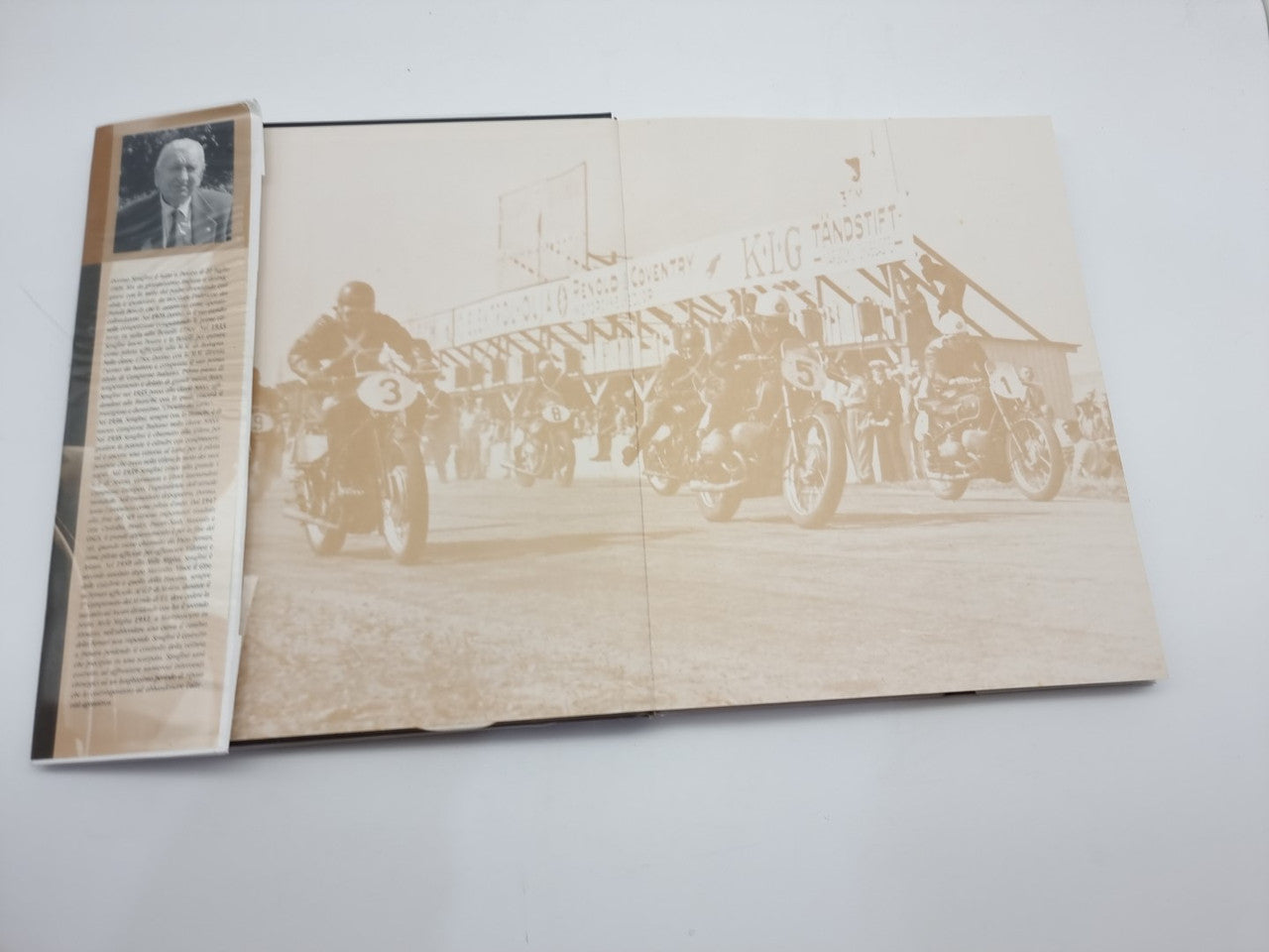Dorino Serafini story-legend book, open pages with sepia vehicle photo and captions