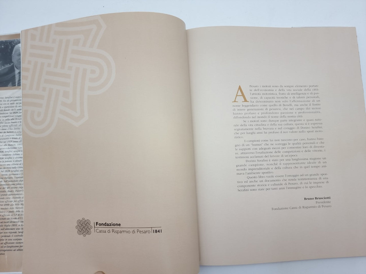 Dorino Serafini story-legend book, open pages with large stylized initial and text