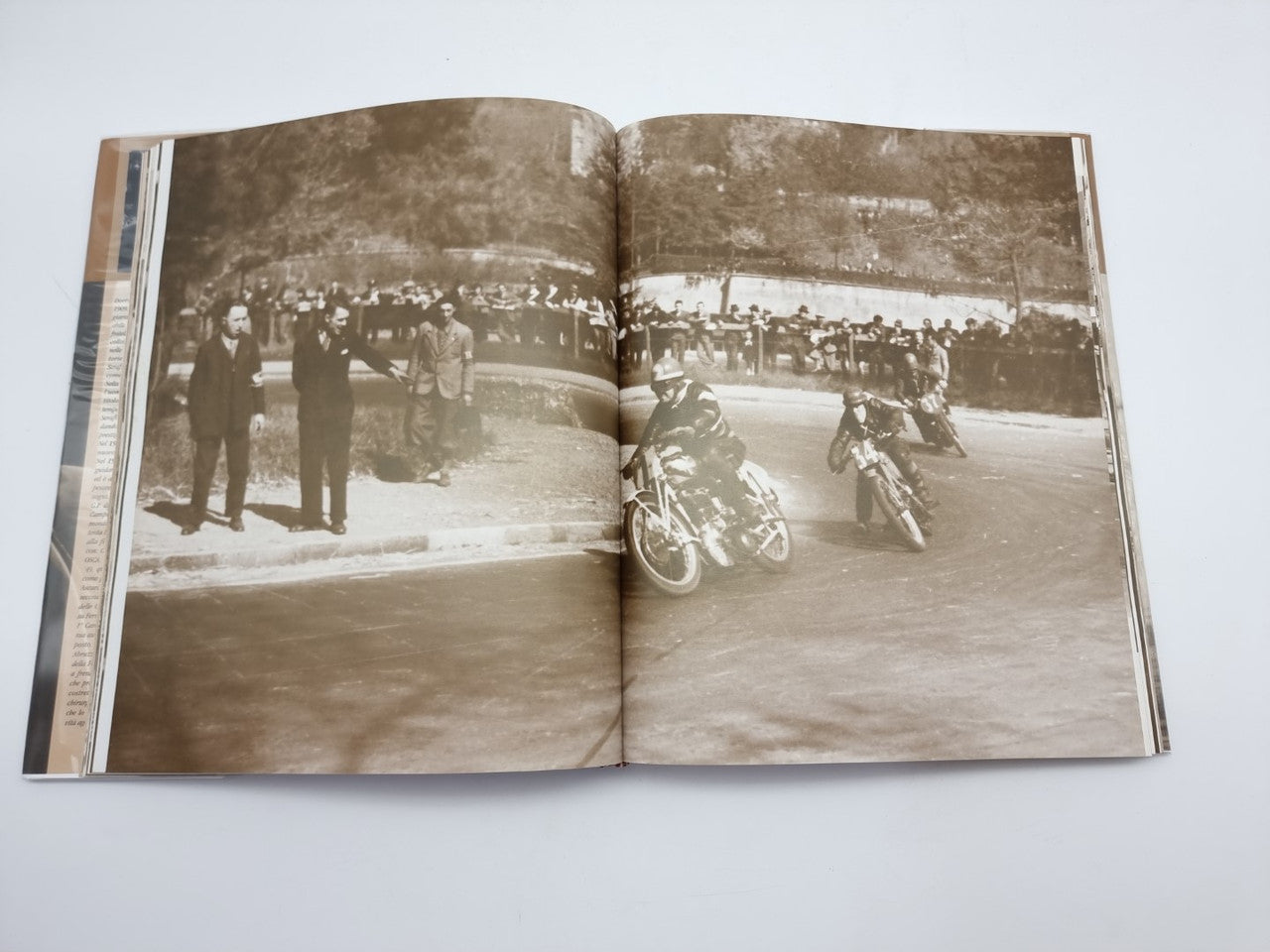 Dorino Serafini story-legend book, open spread with two sepia group-and-bike photos