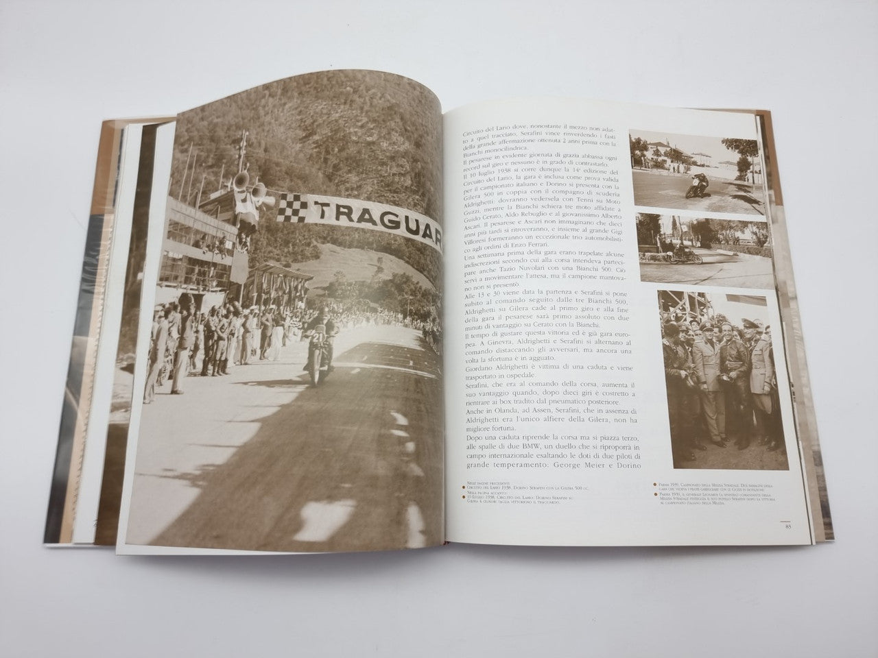 Dorino Serafini story-legend book, open spread with crowd photo and article text