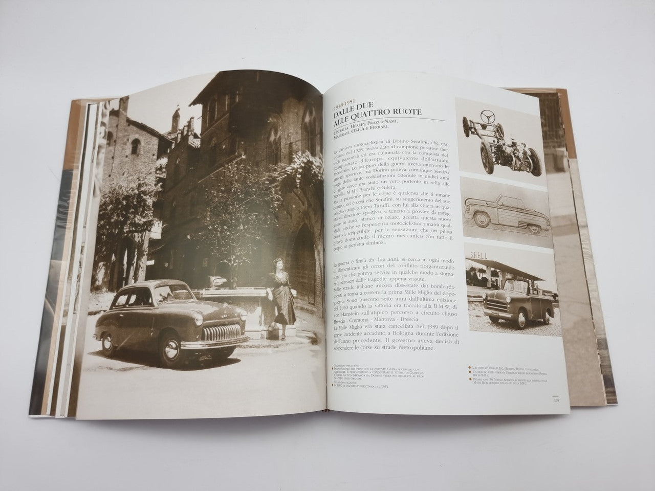Dorino Serafini story-legend book, open pages with street car photo and captions