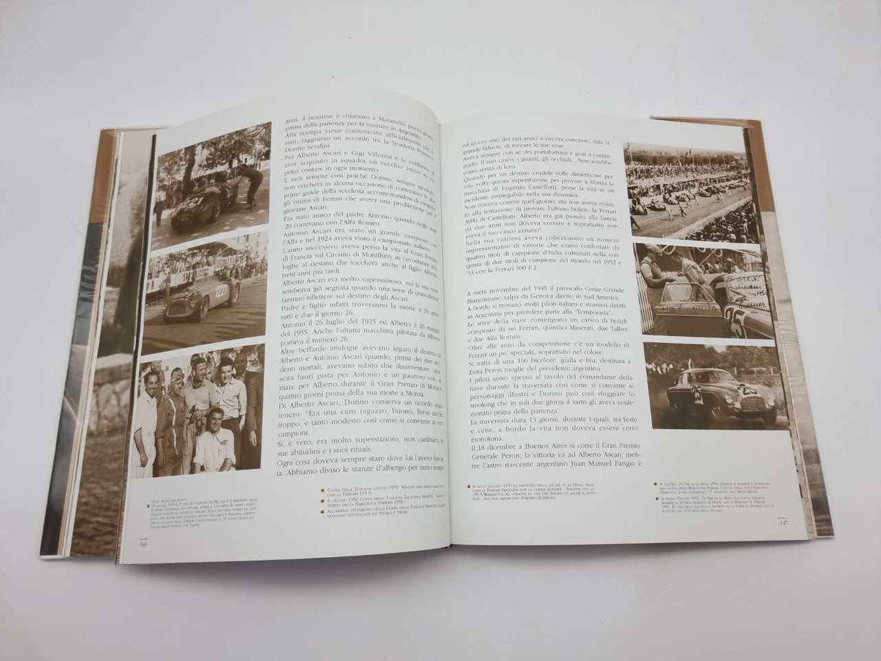 Opened hardcover photo book with text pages and multiple black-and-white images