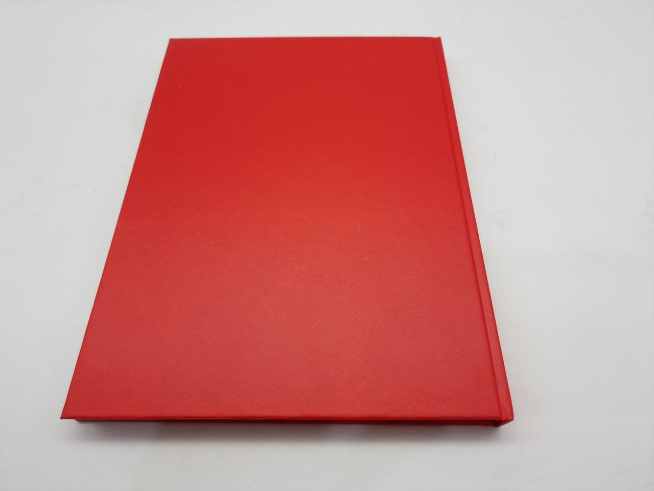 Red hardcover book with plain cover and no visible imagery.
