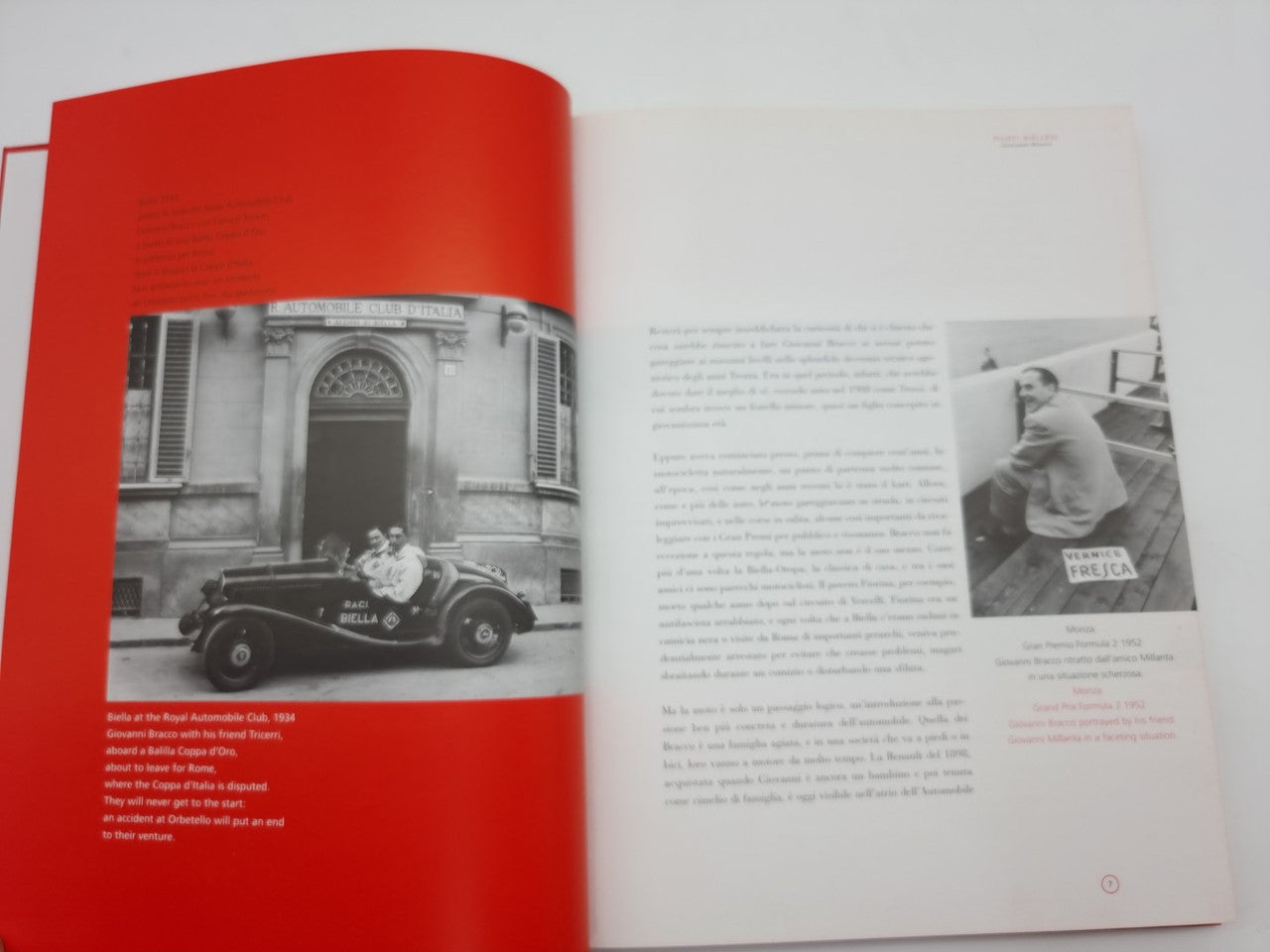 Open book showing red page panel with black-and-white car photo and text.