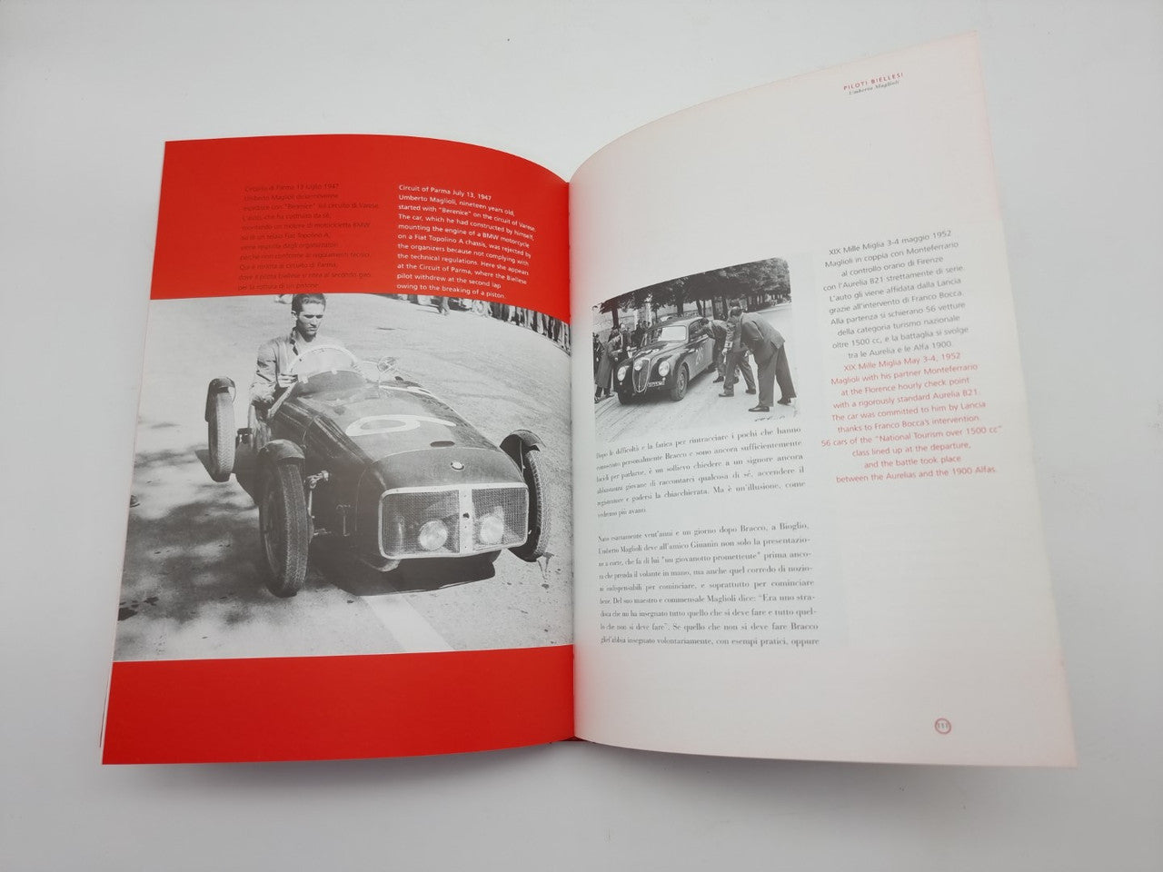 Open book with two black-and-white car photos and red banner sections.