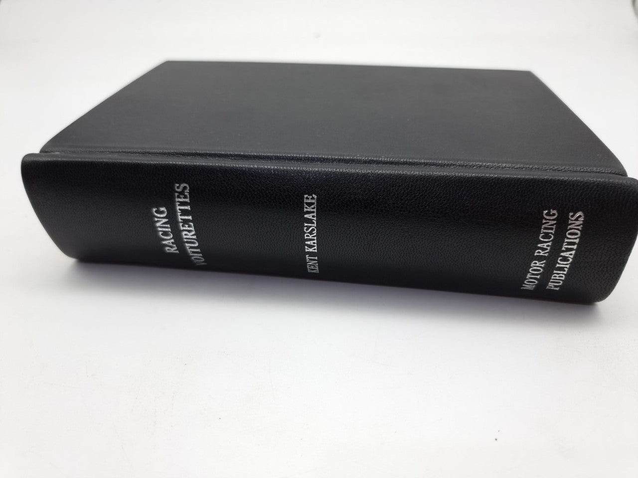 Black hardcover book with textured spine and dark front cover edge