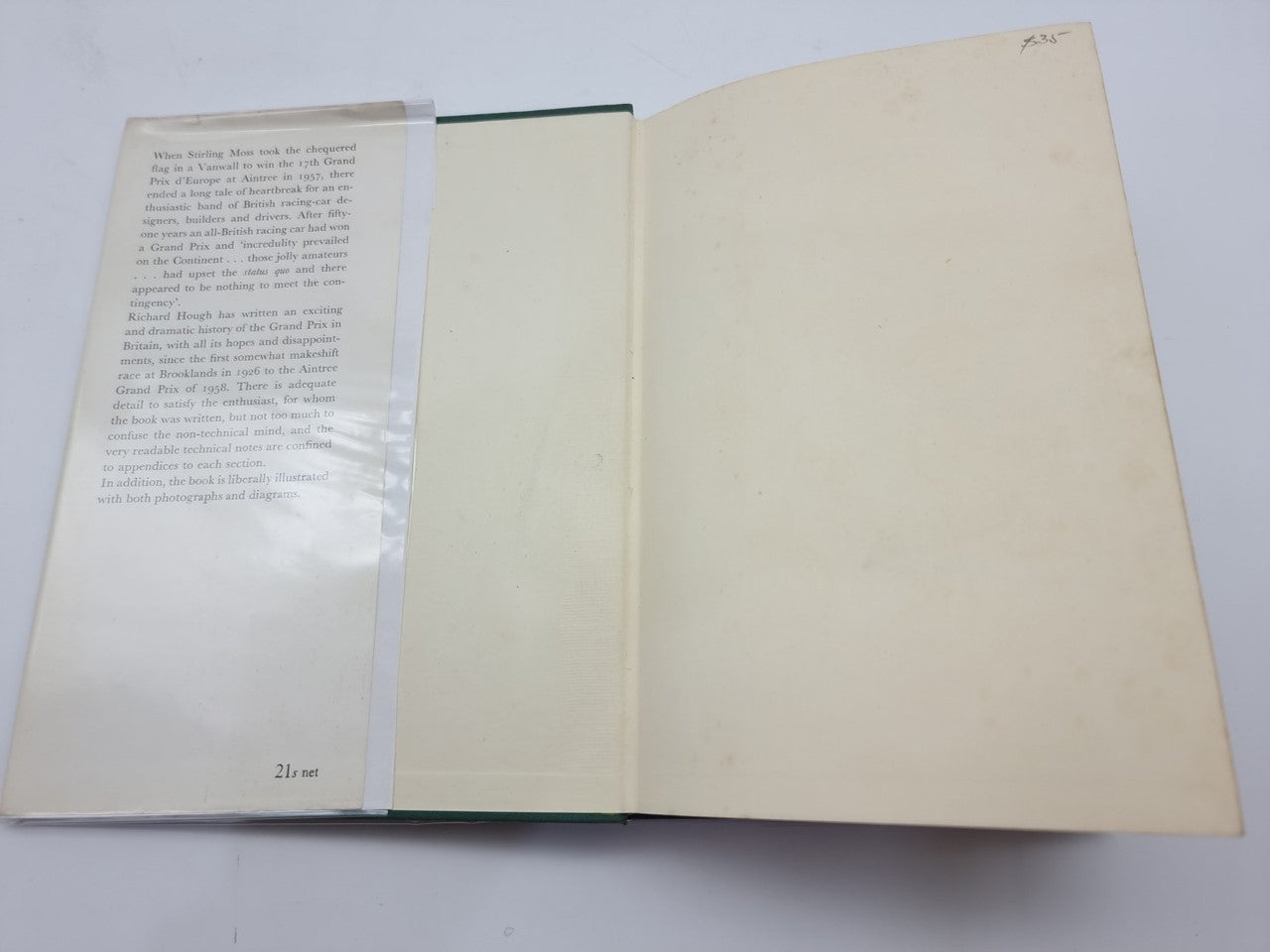 Open hardcover book with cream pages and green binding edge