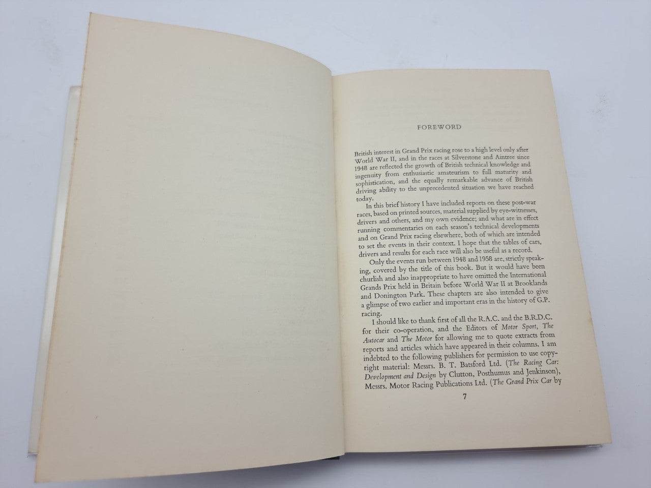Open hardcover book with dense paragraph text on the right page