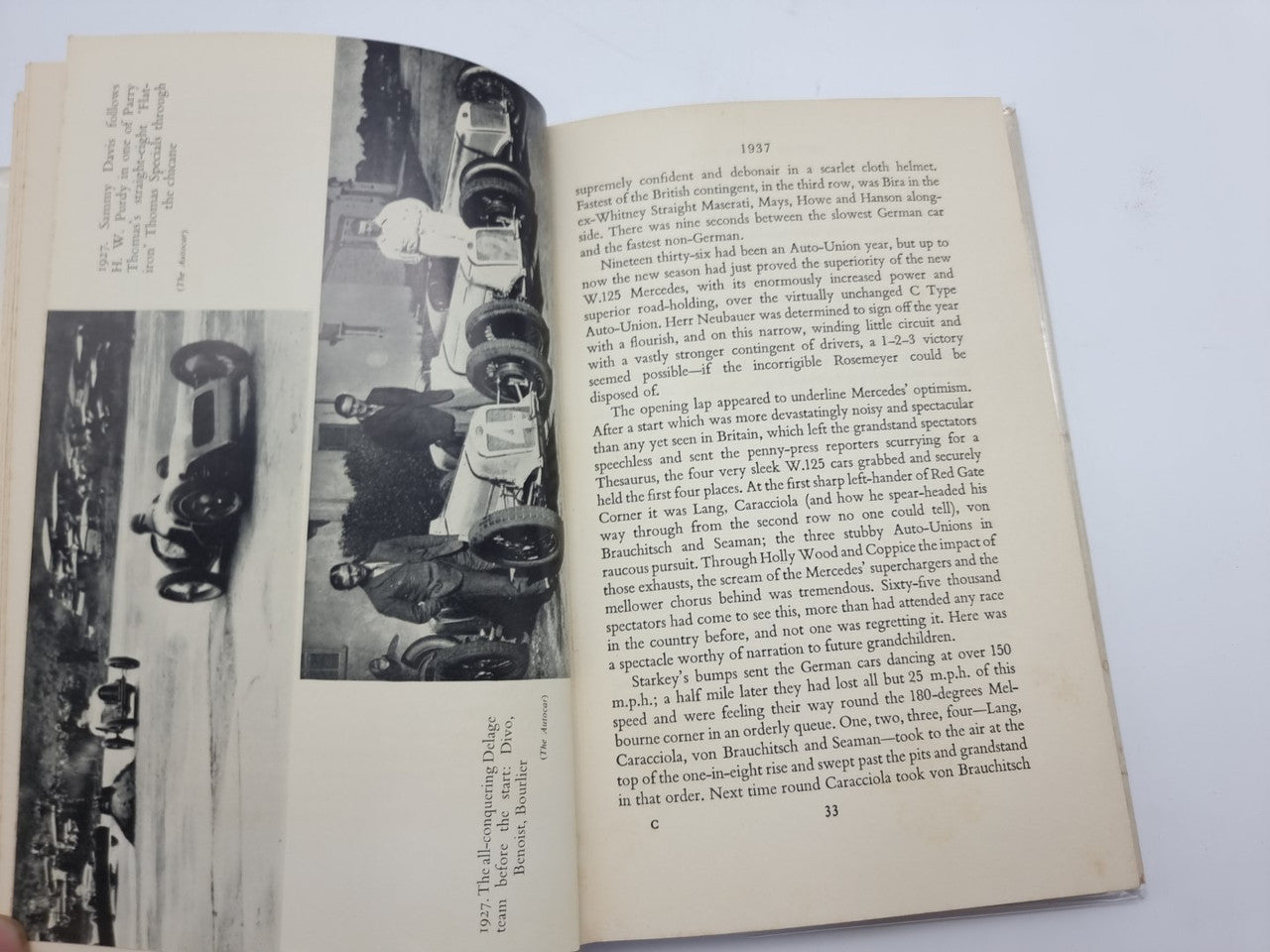 Open hardcover book with vintage photos and captioned text blocks