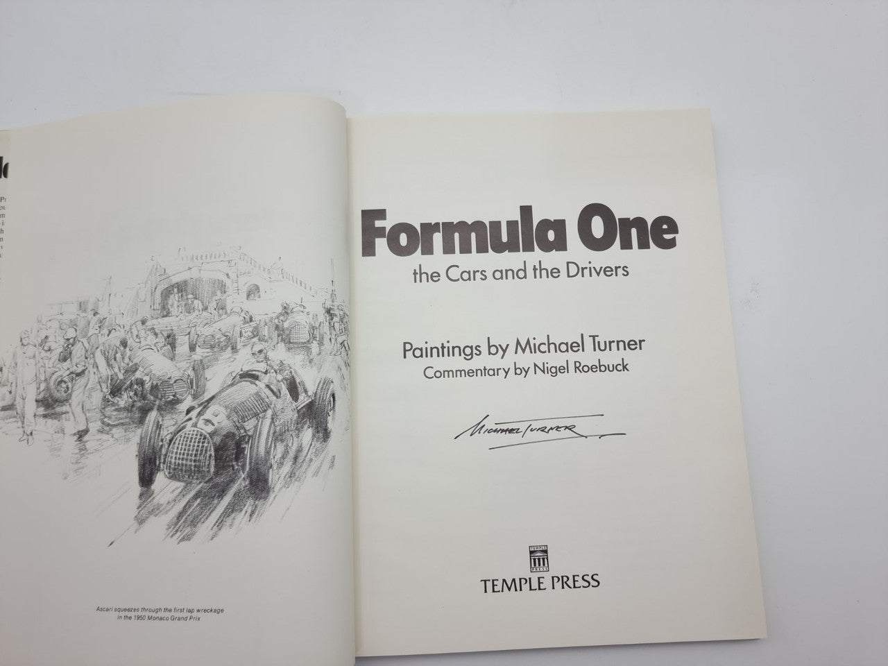 Open Formula One art book with race sketch on left and title page on right