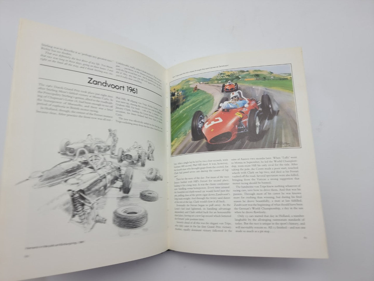 Open Formula One art book with Zandvoort 1961 racing illustration on right