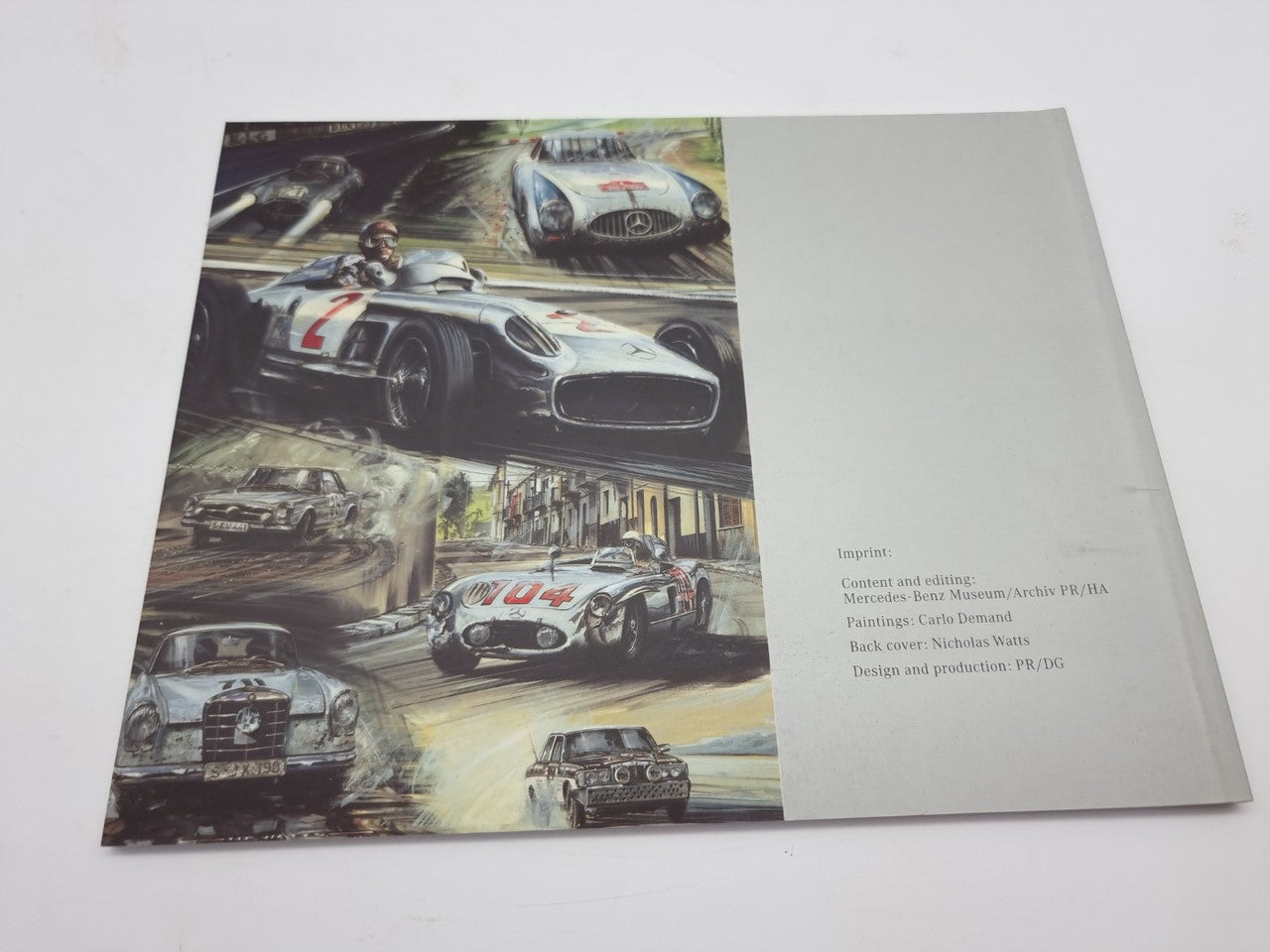 Motorsport history book open spread with collage of race cars on left and info text panel right.