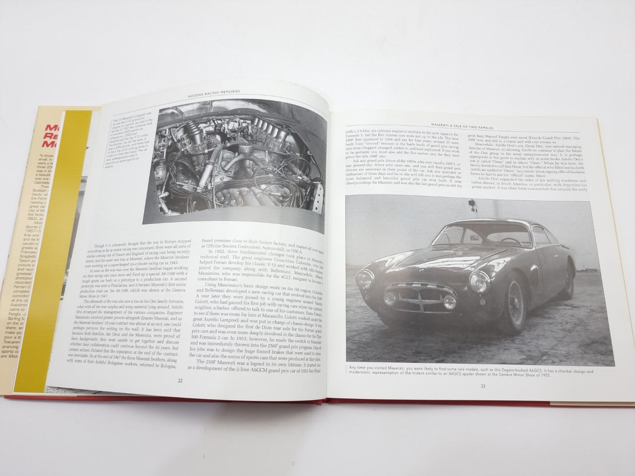 Open book spread with engine diagram photo and classic sports car photo on pages