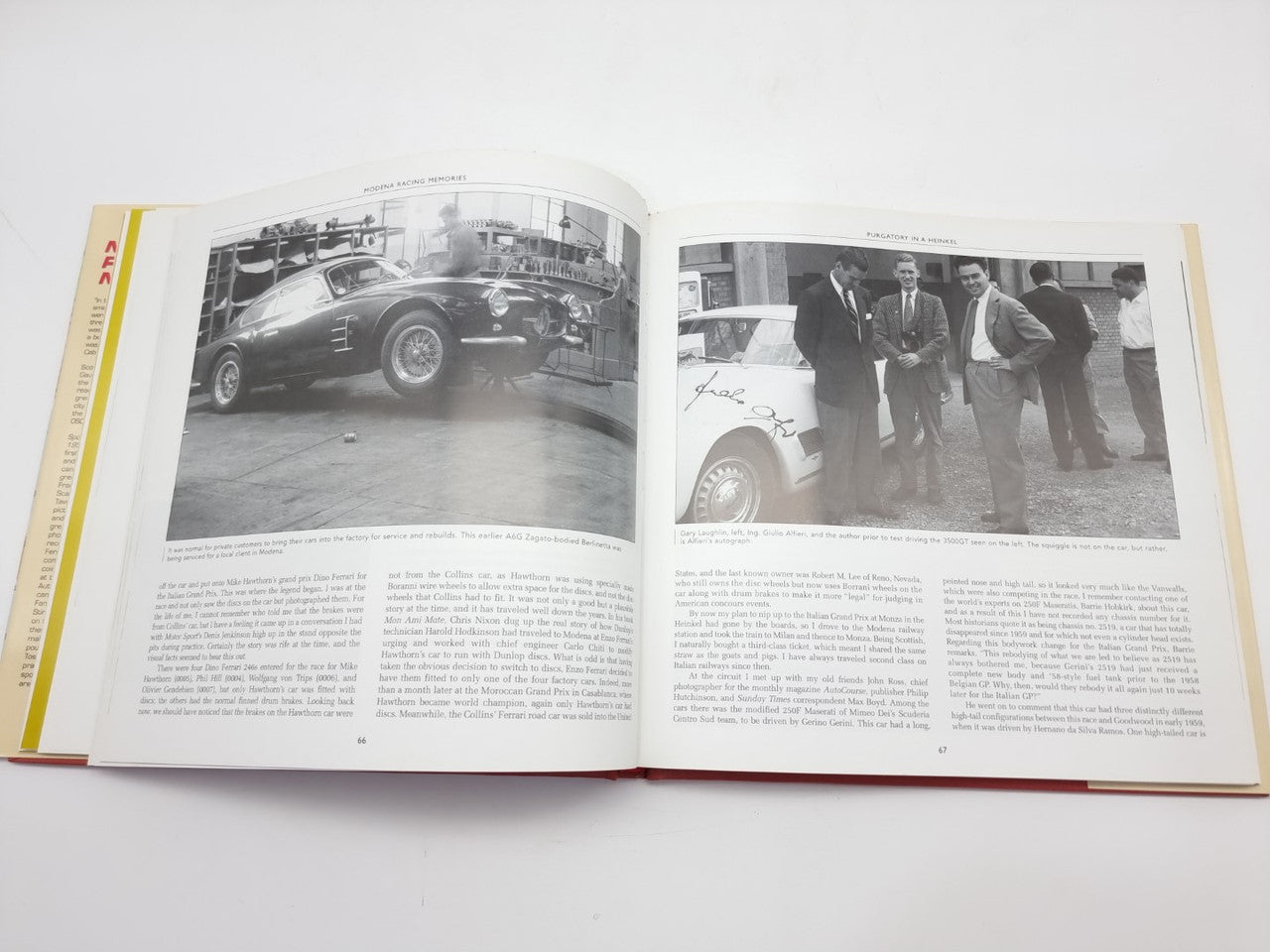 Open racing book with two black-and-white car photographs on facing pages