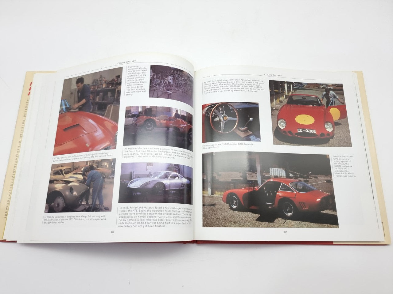Open racing book with red race car photos and close-up cockpit images