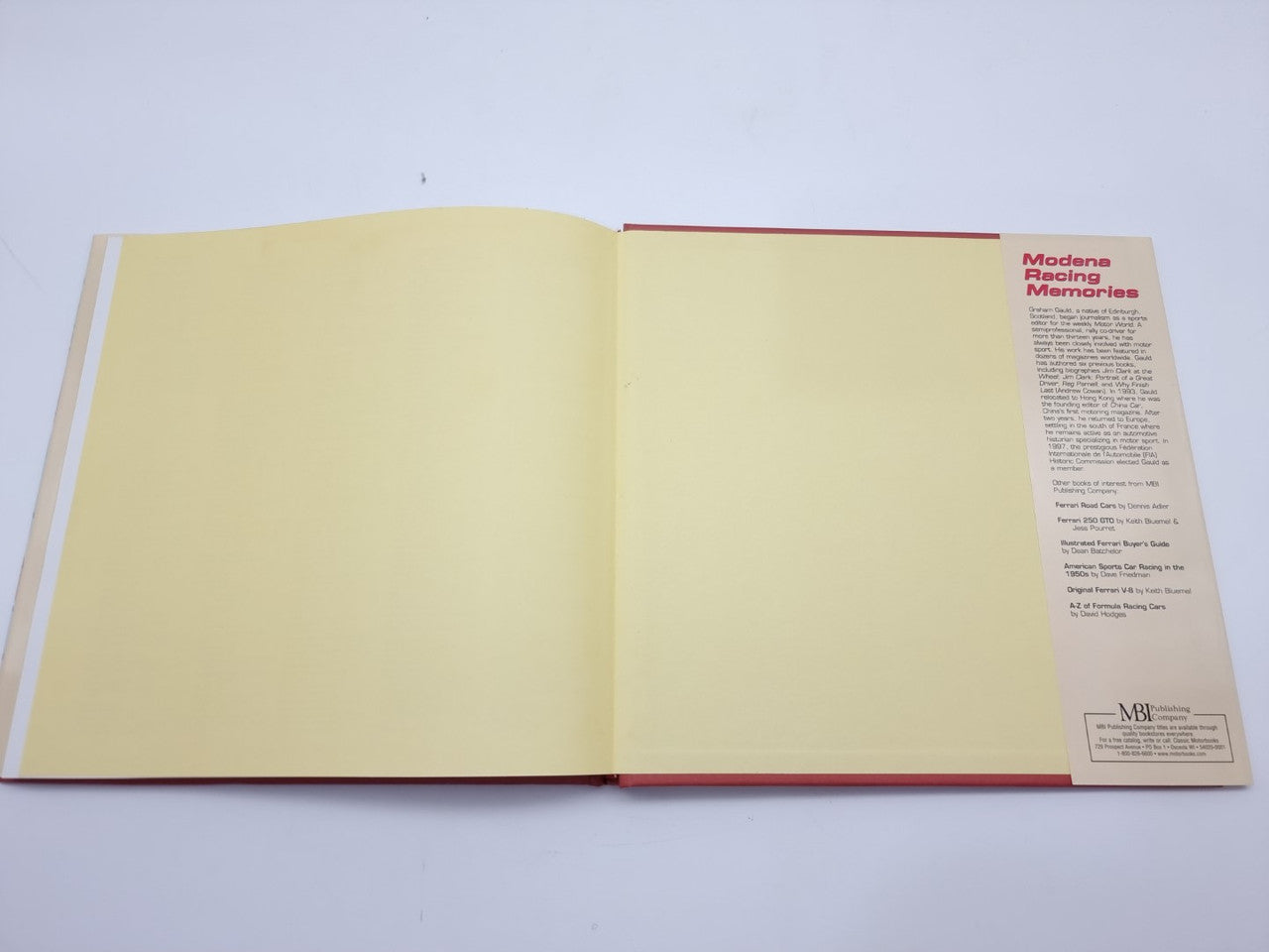 Open racing book with yellow endpapers and publisher info panel on the right