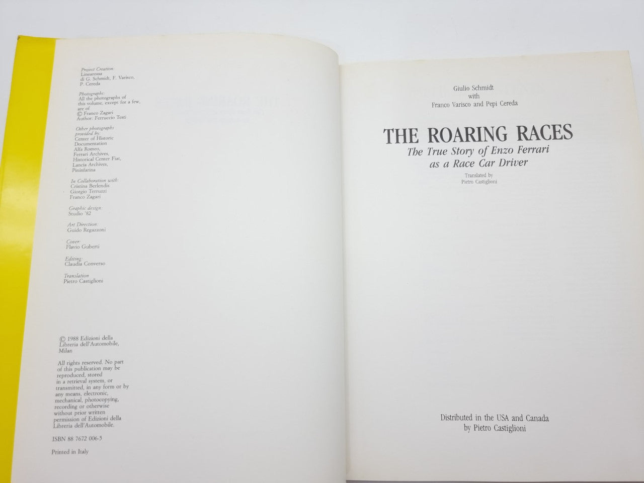 Open hardcover book with text-heavy pages and centered title page on the right