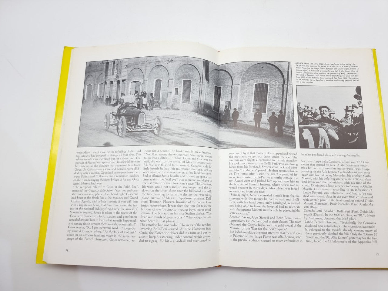 Open hardcover book with black-and-white car photos and dense paragraph text