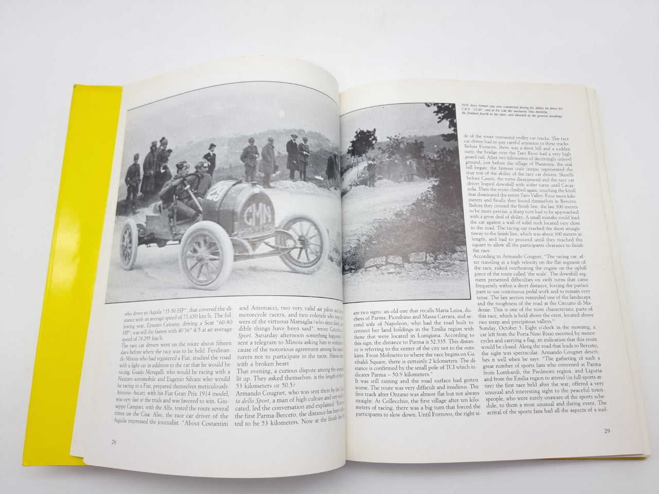 Hardcover race history book open to pages with black-and-white car photos and text