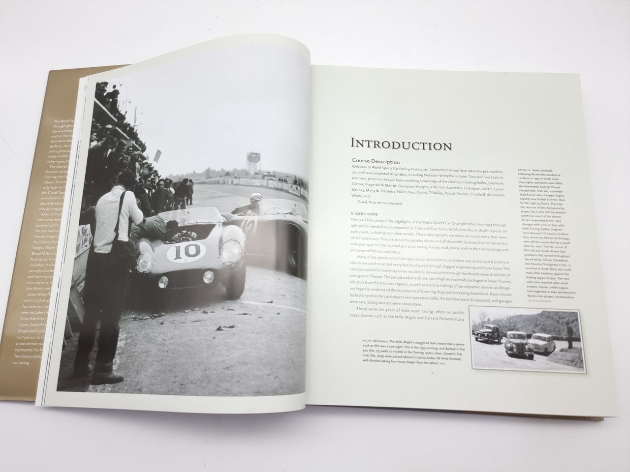 Opened hardcover book spread with black-and-white race car photo and introduction page