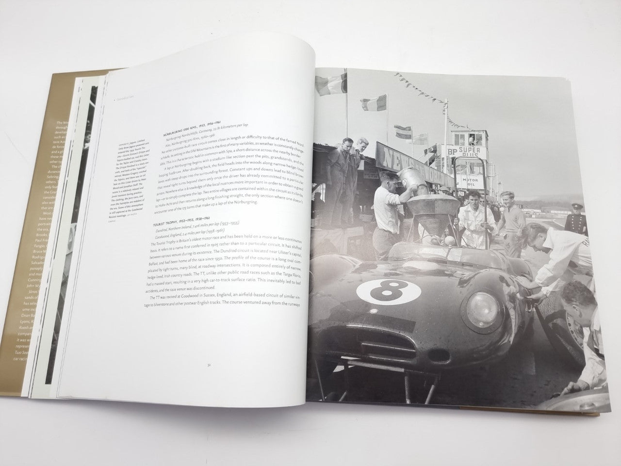 Open book spread showing race car scene and block of printed text.